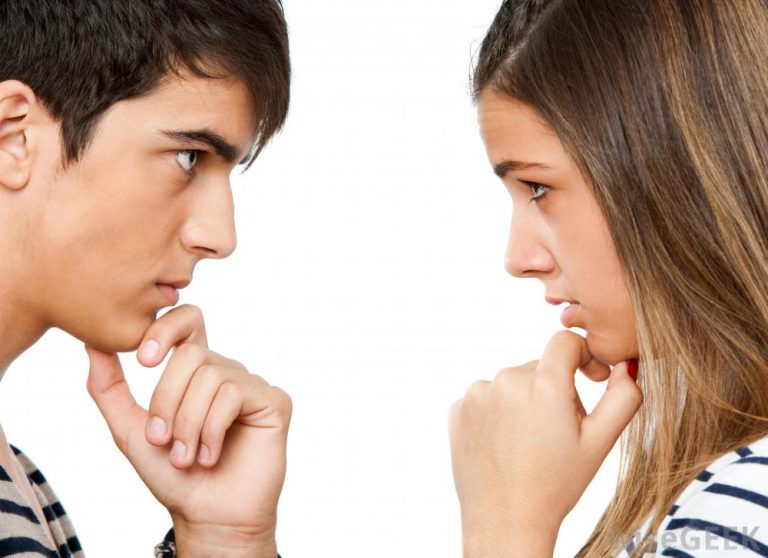 man and woman looking at each other with hands on chins